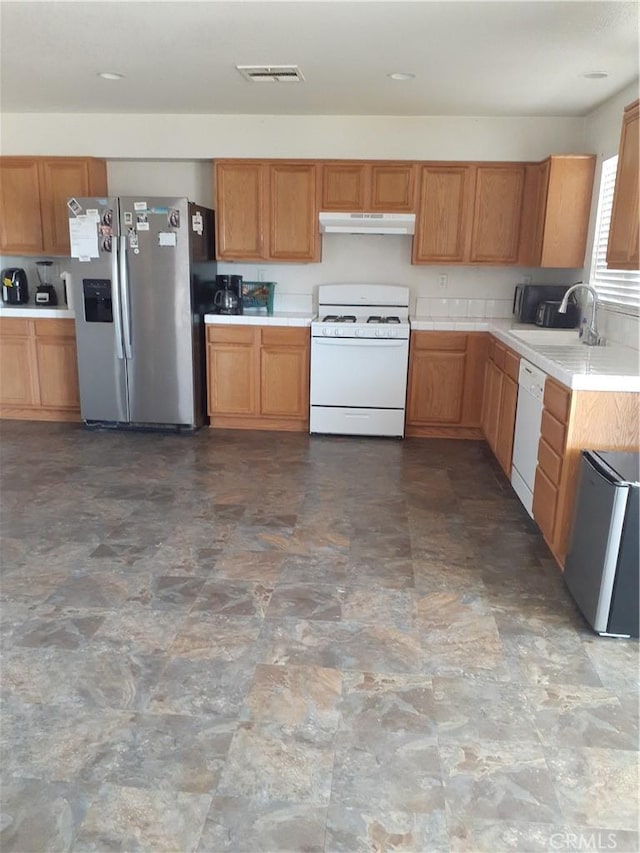 kitchen featuring white appliances and sink