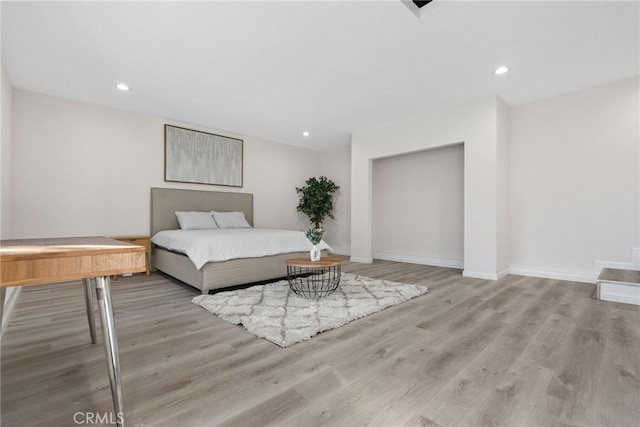 bedroom featuring recessed lighting, baseboards, and wood finished floors