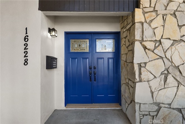 entrance to property with french doors and stone siding