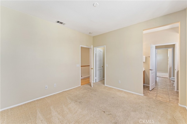 unfurnished bedroom featuring light carpet