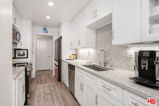 kitchen with white cabinets, sink, and stainless steel appliances