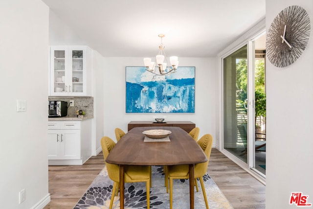 dining room featuring a notable chandelier and light hardwood / wood-style floors