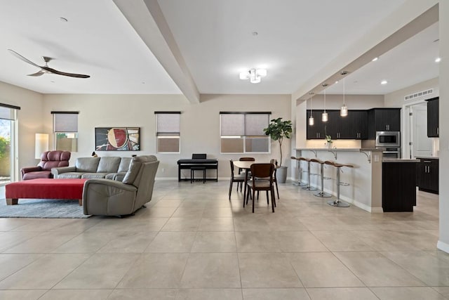 living room featuring light tile patterned flooring, ceiling fan, and beamed ceiling