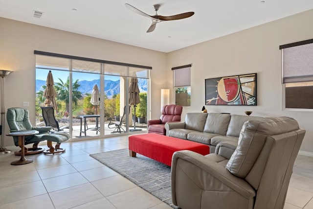 living room featuring ceiling fan and light tile patterned floors