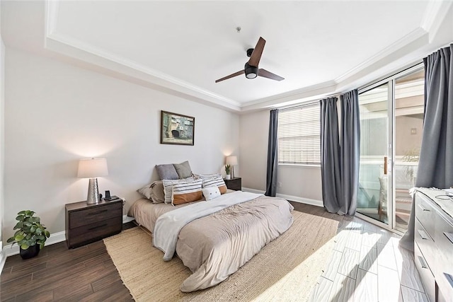 bedroom featuring ceiling fan, hardwood / wood-style floors, access to outside, and a raised ceiling