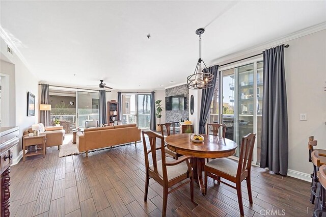 dining space featuring crown molding and ceiling fan with notable chandelier