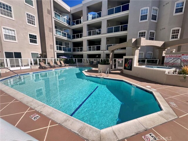 view of pool featuring a hot tub