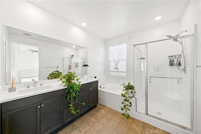 bathroom featuring vanity and separate shower and tub