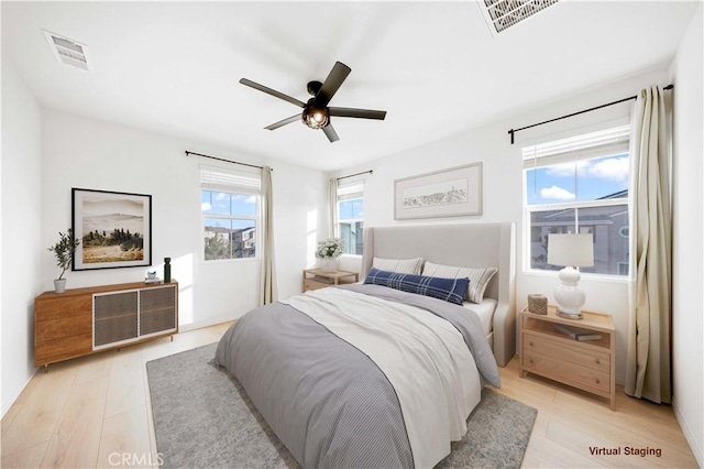 bedroom with light wood-type flooring and ceiling fan