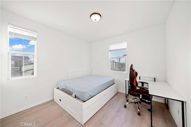 bedroom with light hardwood / wood-style flooring