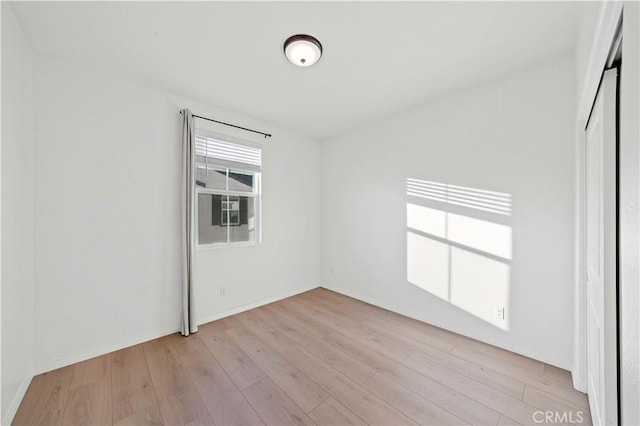 unfurnished room with light hardwood / wood-style flooring