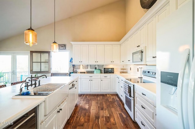 kitchen featuring white appliances, white cabinetry, tasteful backsplash, hanging light fixtures, and high vaulted ceiling