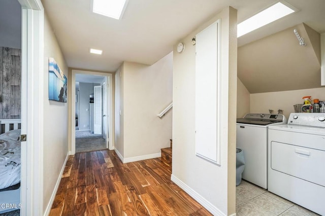 laundry room with washer and dryer and light hardwood / wood-style flooring