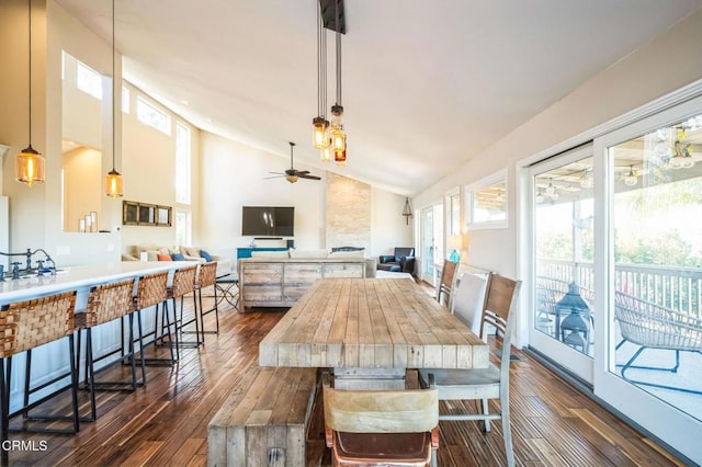 dining space featuring high vaulted ceiling, dark hardwood / wood-style floors, and ceiling fan