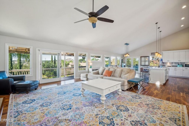 living room featuring ceiling fan, dark wood-type flooring, and high vaulted ceiling