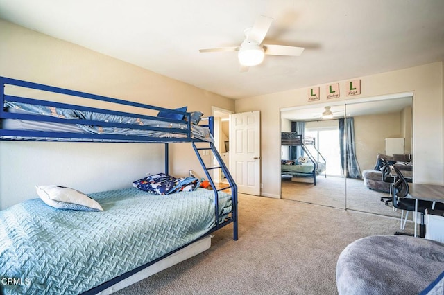 carpeted bedroom featuring ceiling fan and a closet