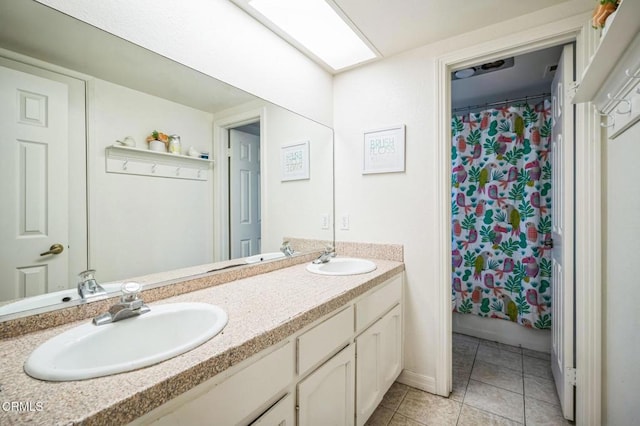 bathroom featuring tile patterned flooring, vanity, a skylight, and a shower with curtain