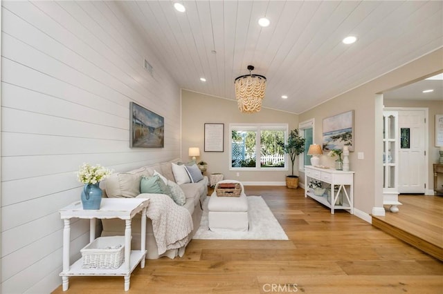 living room with wooden ceiling, hardwood / wood-style floors, a notable chandelier, and vaulted ceiling