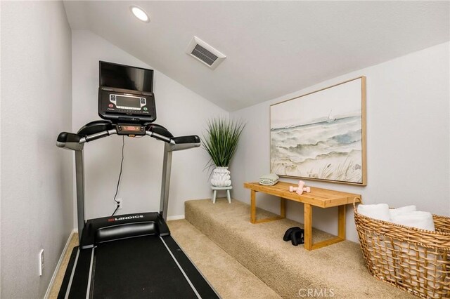 exercise area with lofted ceiling and carpet flooring