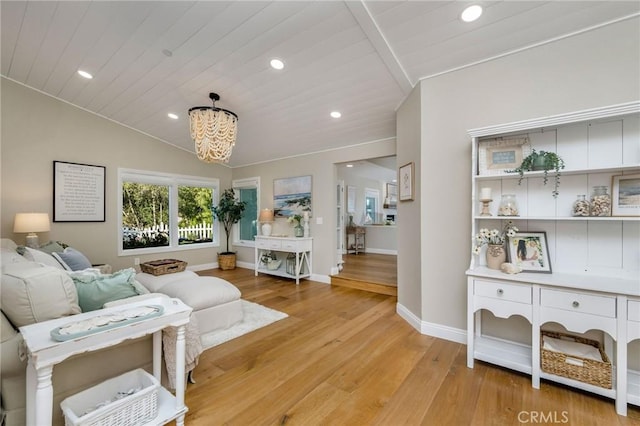 living room featuring wood ceiling, light hardwood / wood-style flooring, lofted ceiling, and a chandelier