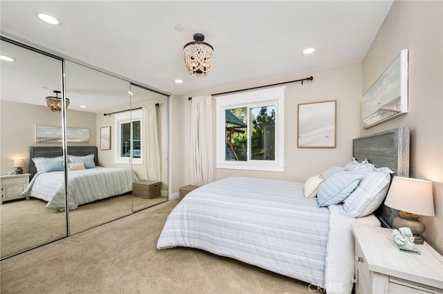 bedroom with light colored carpet and a closet