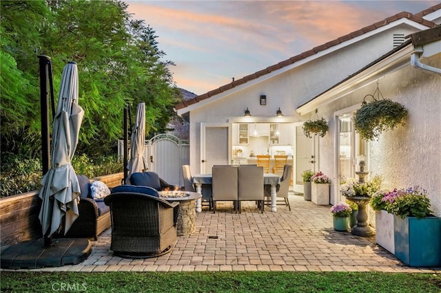 patio terrace at dusk with a fire pit