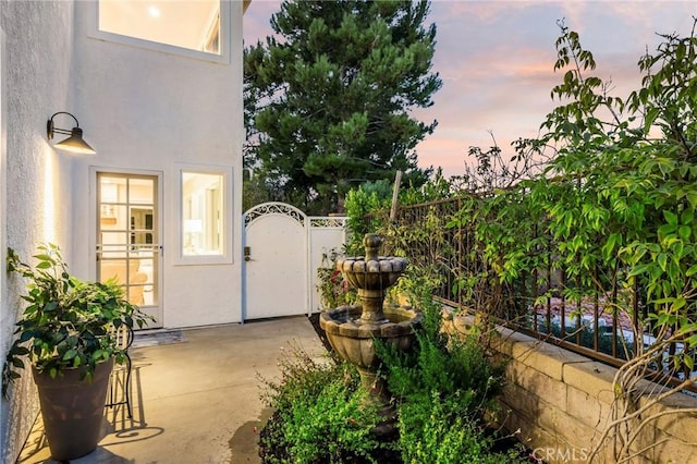 view of patio terrace at dusk