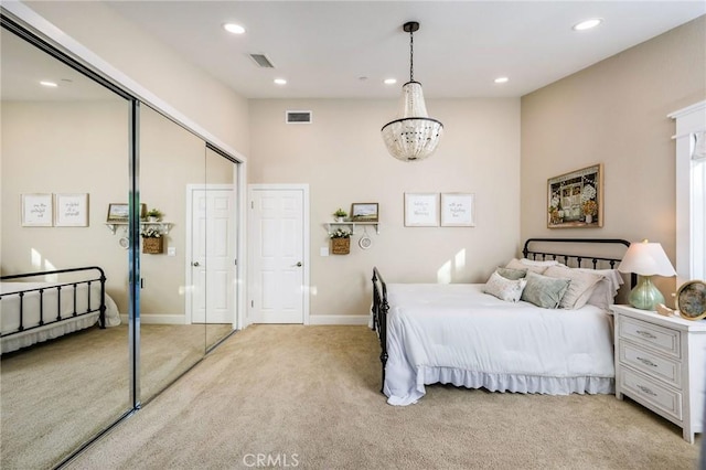 carpeted bedroom with a chandelier