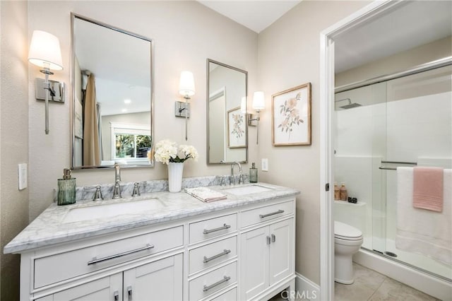 bathroom featuring walk in shower, vanity, tile patterned floors, and toilet