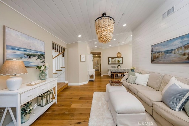 living room with vaulted ceiling, hardwood / wood-style flooring, a chandelier, and wooden ceiling