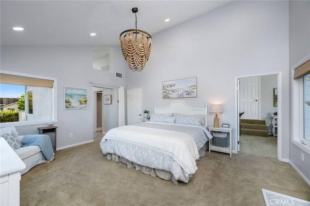 bedroom featuring high vaulted ceiling, light carpet, and a chandelier