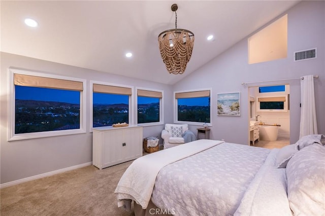 carpeted bedroom featuring an inviting chandelier, ensuite bathroom, and lofted ceiling