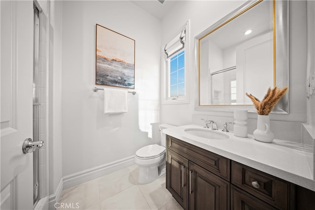 bathroom featuring toilet, vanity, tile patterned floors, and a shower with door