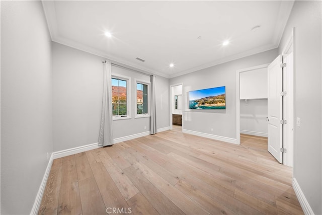 unfurnished living room with light hardwood / wood-style floors and ornamental molding