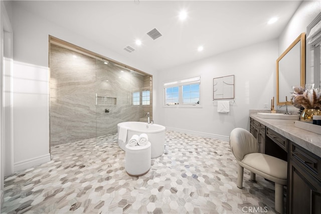 bathroom featuring vanity and plus walk in shower