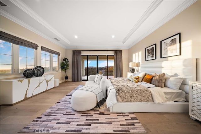 bedroom with light hardwood / wood-style floors and ornamental molding