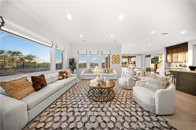 living room with a wealth of natural light and ornamental molding