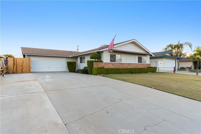 single story home featuring a front lawn and a garage