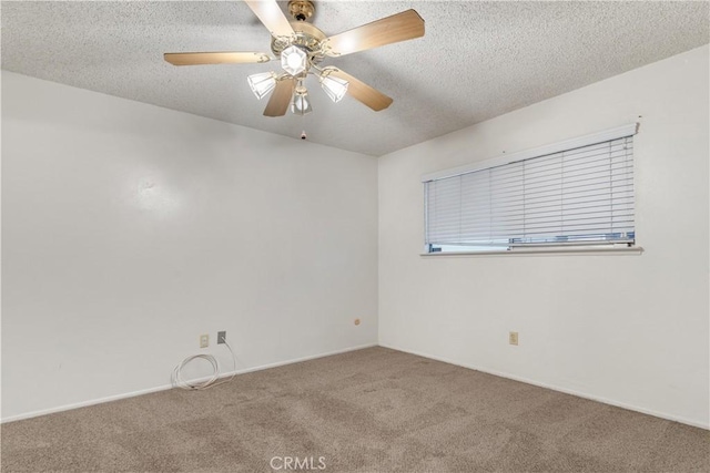 carpeted spare room with a textured ceiling and ceiling fan