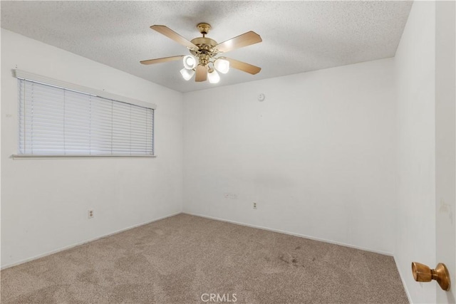 empty room with light carpet, ceiling fan, and a textured ceiling