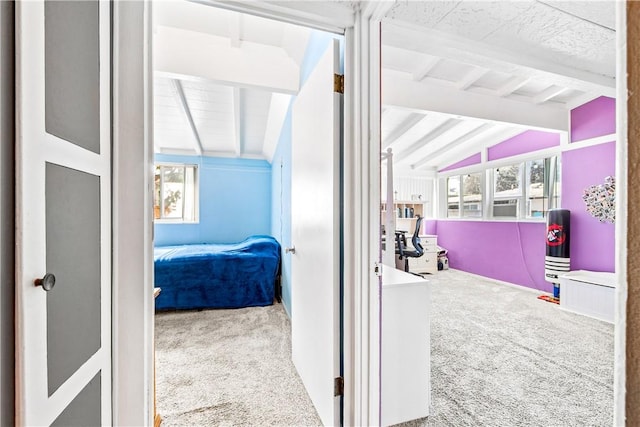 hall featuring lofted ceiling with beams and carpet floors