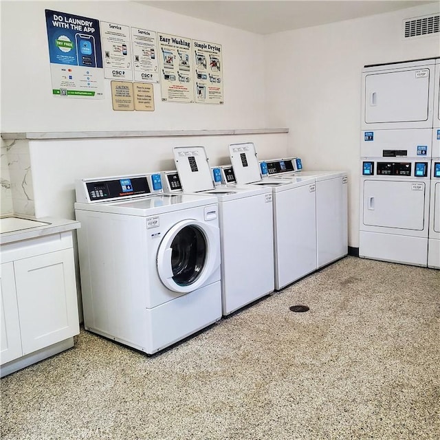 washroom featuring washing machine and dryer and stacked washer / drying machine