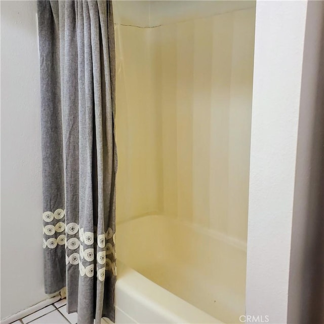 bathroom featuring shower / tub combo and tile patterned flooring