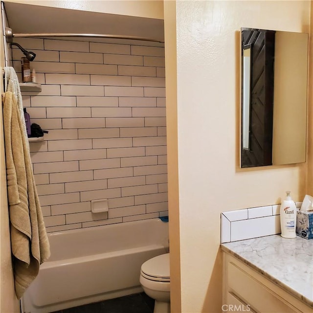 full bathroom featuring toilet, tiled shower / bath, and vanity