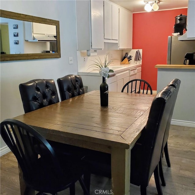 dining area with light hardwood / wood-style floors