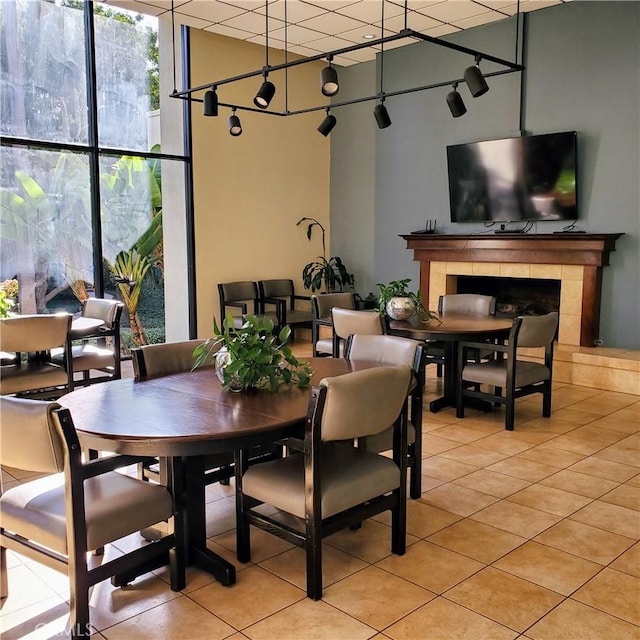 tiled dining room with a tile fireplace