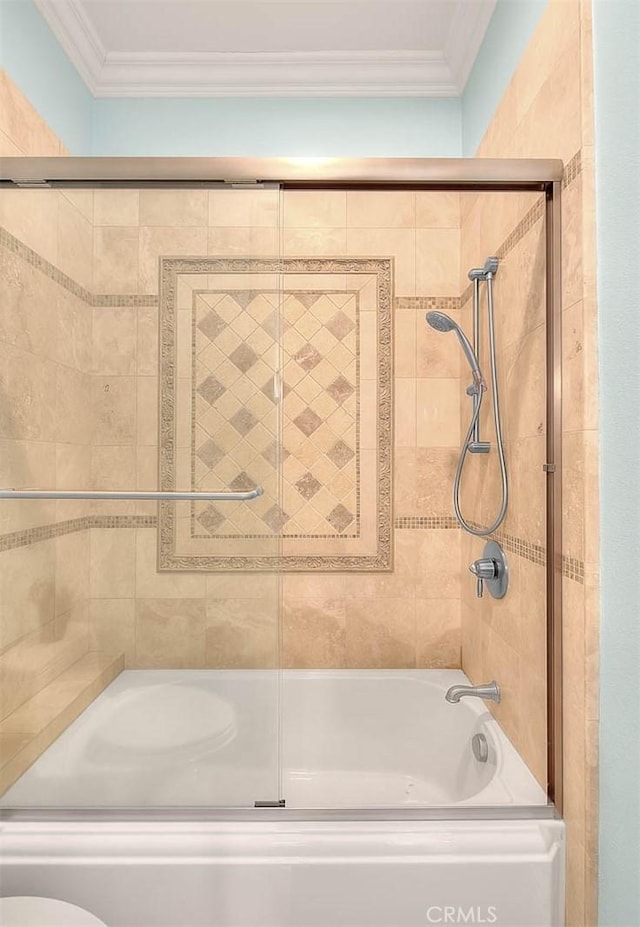 bathroom with ornamental molding, toilet, and combined bath / shower with glass door