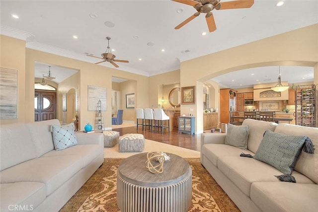 living room featuring ceiling fan and ornamental molding