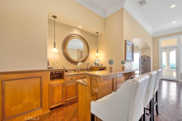 dining room with ornamental molding and dark wood-type flooring