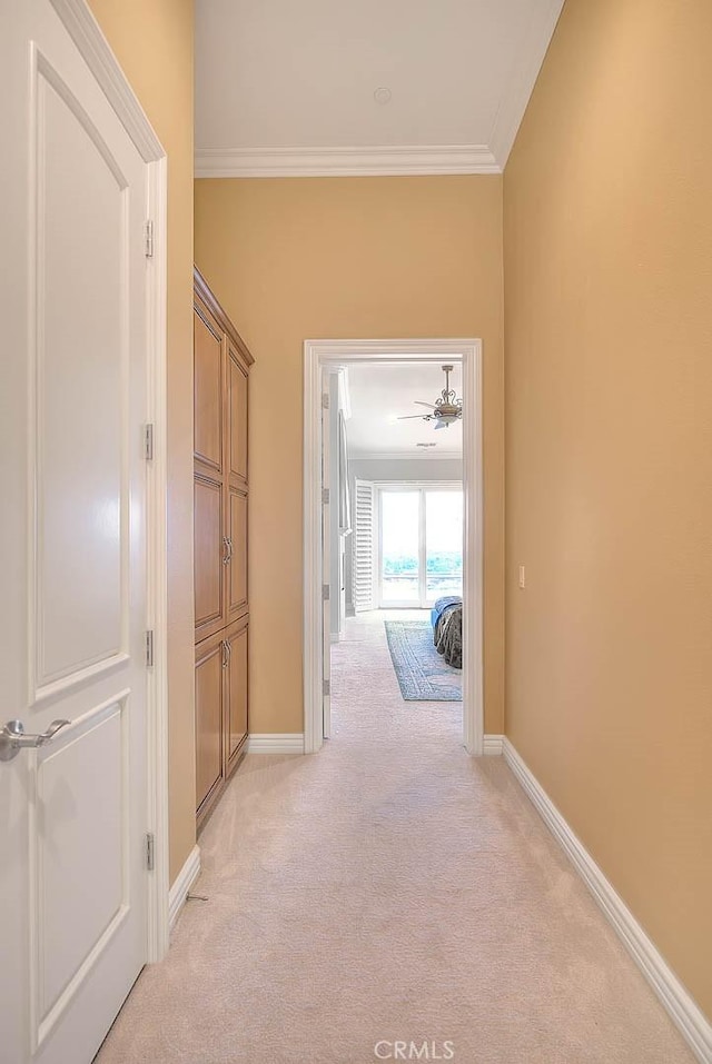 hall featuring crown molding and light carpet